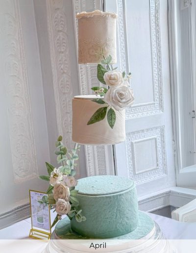 Floating tier wedding cake with mint green base and sugar flowers