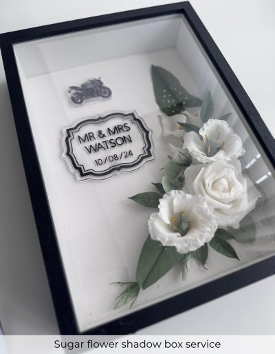 Preserved sugar flowers in a personalised wedding shadow box with couple’s name and date