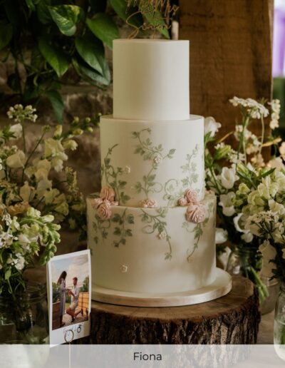 Bespoke luxury wedding cake with hand-painted green vines and sugar roses, styled for a wedding at Hazel Gap Barn in Nottinghamshire