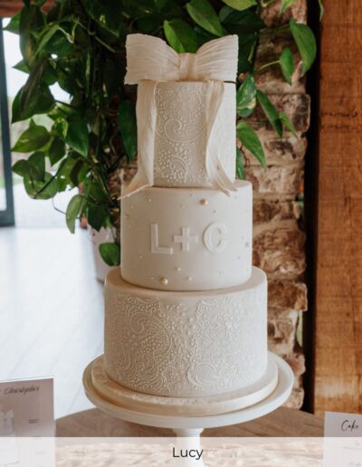 Bespoke luxury wedding cake with stencilled lace tiers and monogram detail, styled for a wedding at Hazel Gap Barn in Nottinghamshire