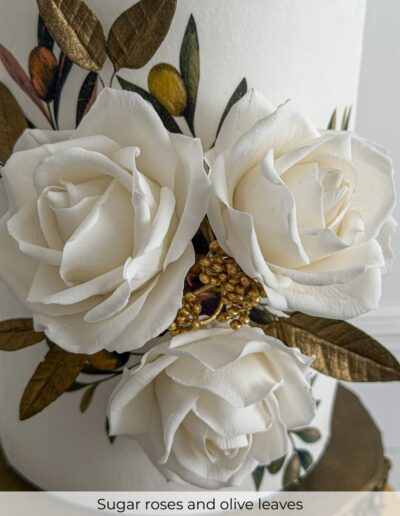 Three white sugar roses with metallic olive leaves, golden berries and hand-painted botanical details.
